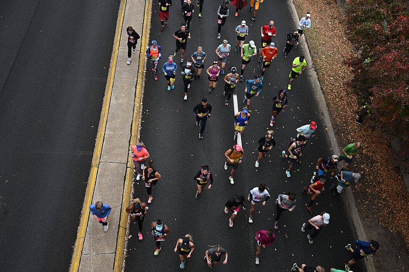 Runners jog down La Harpe Boulevard at the start of the Little Rock Marathon on Sunday, Nov. 21, 2021. See more photos at arkansasonline.com/1121lrmarathon/ (Arkansas Democrat-Gazette/Stephen Swofford)