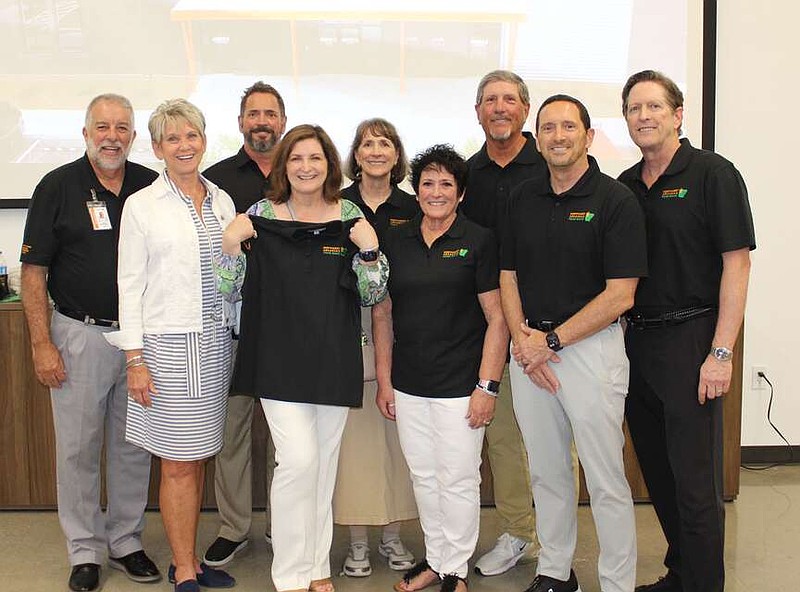 Northwest Arkansas Food Bank President and CEO Kent Eikenberry and wife Diana (from left) and Tim Harris, Gayla Harris, Paula Harris Stansell, Theresa Moore, Don Harris, Gary Harris and David Harris welcome guests to celebration July 31 in celebration of the opening of the Claude and Betty Harris Center for Hunger Relief, which is named in honor of their parents.
(NWA Democrat-Gazette/Carin Schoppmeyer)