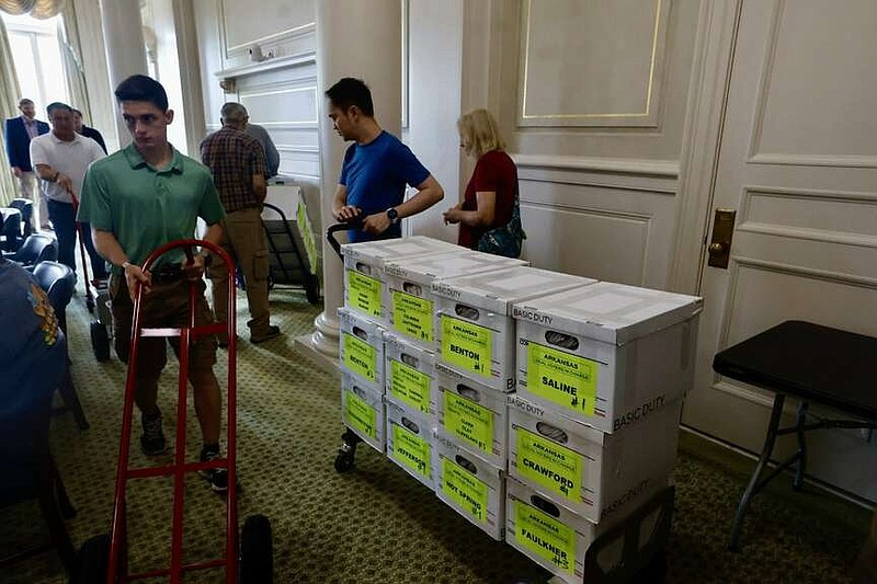 FILE - Volunteers deliver signatures for the repeal Pope County casino amendment at the state Capitol on July 5. (Arkansas Democrat-Gazette/Thomas Metthe)